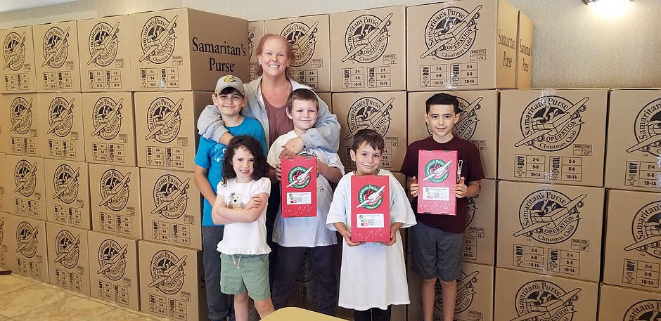 Kelly Clark out of Cinco Baptist Church in Fort Walton Beach stands with additional Operation Christmas Child volunteers. They had over 2,000 shoeboxes dropped off on the first day of National Collection Week of the OCC program. The regional OCC organizers thank the community for walking along side this ministry and giving other children across the world the opportunity to learn about Jesus.