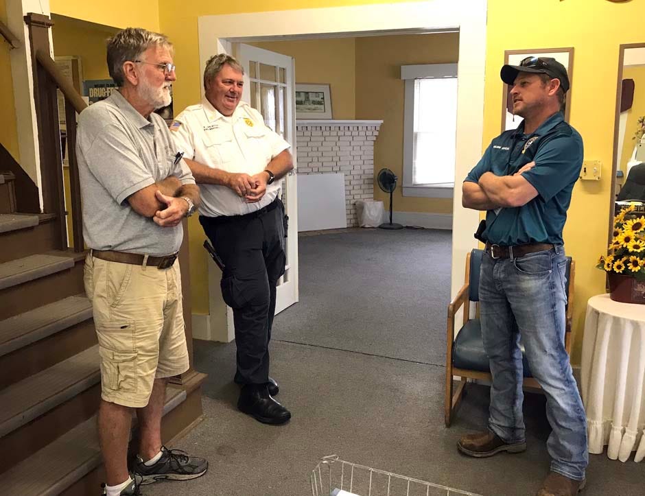 Contractor Rick Rausch, who specializes in historic building restoration, Crestview Fire Marshal Rodney Lancaster, and city building official Ronnie Raybon stand in the Bush House’s front hall recently in Crestview. They are discussing the challenges of renovating the 1925 landmark.