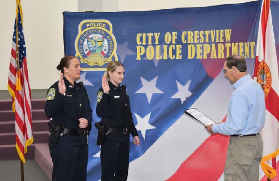 Crestview Mayor J.B. Whitten swears in new Crestview Police Department Officer Sarah Althuisius, center, and Officer Kristy Peters Dec. 21 in Crestview.