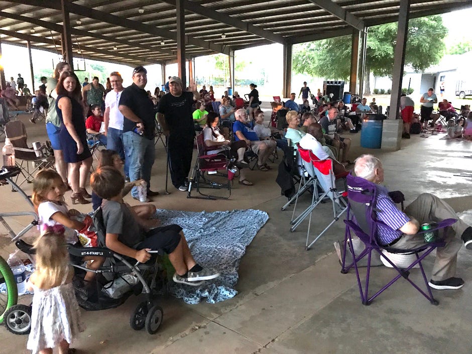 Families and neighbors socialize before the start of a previous Family Movie Night feature at the Twin Hills Park amphitheatre in Crestview.