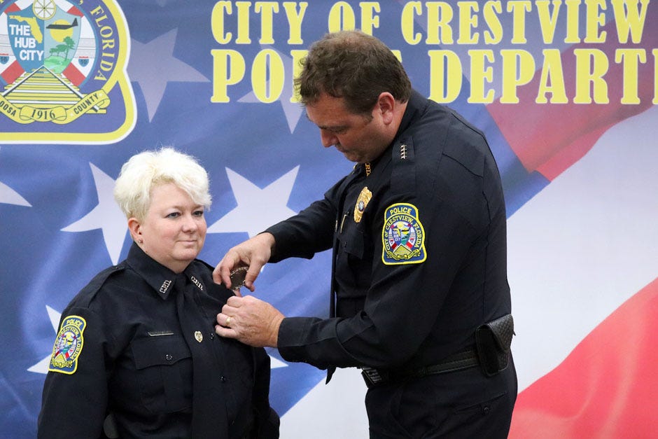 Crestview Police Chief Stephen McCosker pins on his newest officer’s badge during Kimberley Beasley’s swearing-in ceremony Sept. 16 in Crestview.