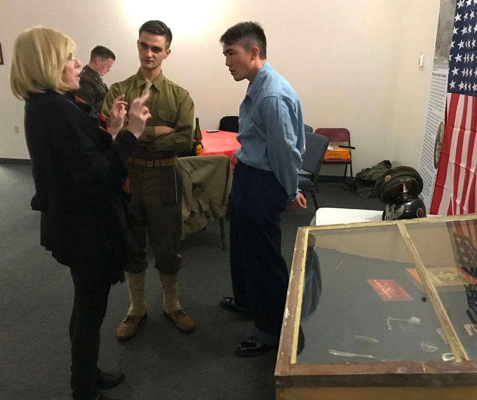 World War II reenactors Zach Panici and Danny Clark discuss history with a patron during Crestview’s “Swing into the Season” big band dance Nov. 27 in Crestview.