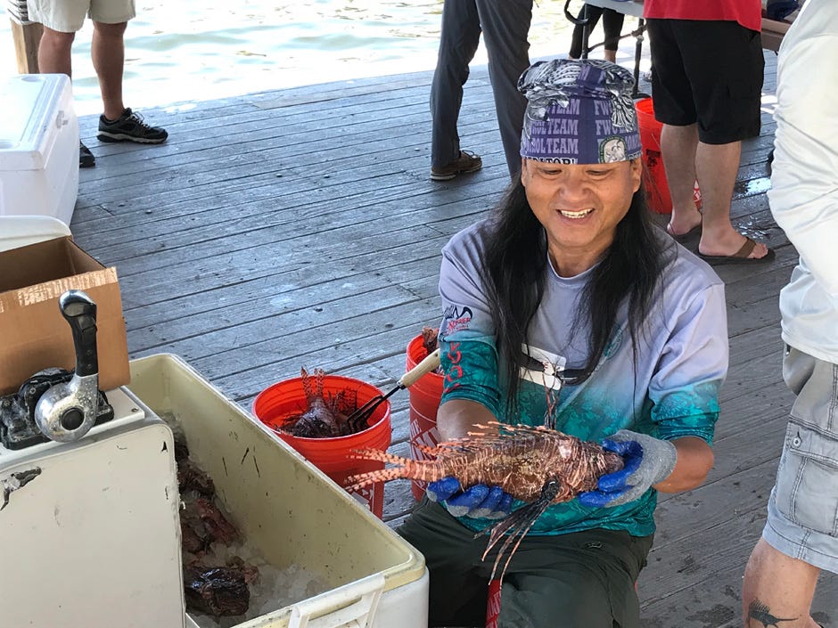 A participant shows one of the 10,250 invasive lionfish caught during the Emerald Coast Open May 14-16 in Destin. The event is the largest lionfish tournament in the world, and more than 145 people participated in it this year.