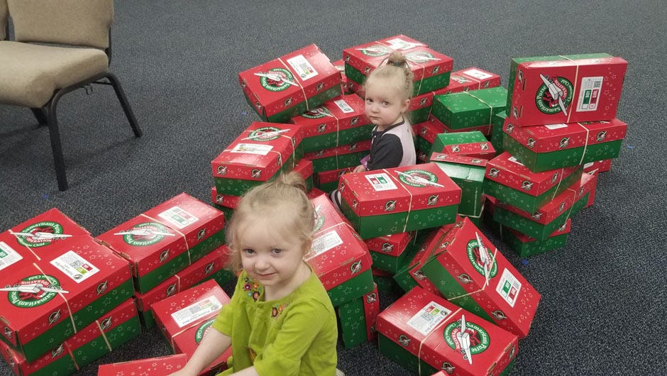 Quinn and Aubry Witcher, the children of Operation Christmas Child Director Faith Witcher, helped as boxes were packed and shipped to the Samaritans Purse organization.