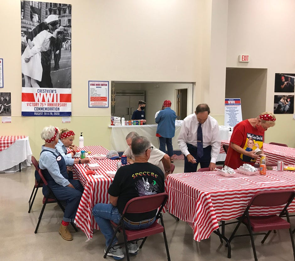 Participants enjoy a hotdog lunch at the Stage Door Canteen staffed by students from the Sister City Ambassadors club during the August 2020 World War II Victory 75th Anniversary Commemoration, for which the Crestview Area Sister City Program was the community sponsor.