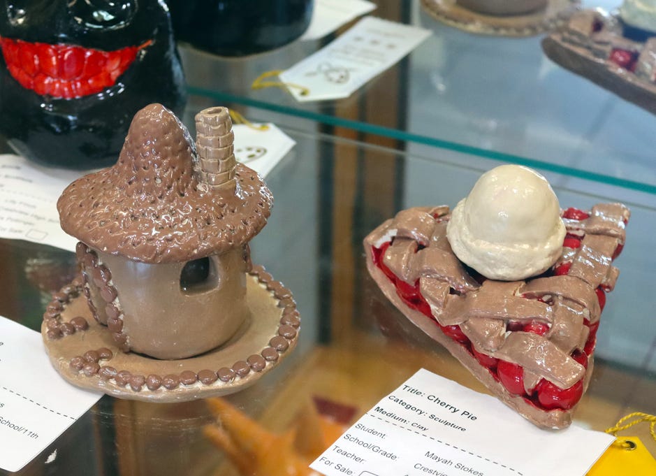 “Insence,” a whimsical incense burner, and a slice of “Cherry Pie,” both by Mayah Stokes, can be seen — but not smelled or tasted — in a lobby display case at the Crestview Public Library.