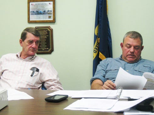 Laurel Hill City Council Chairman Larry Hendren observes as Councilman Scott Moneypenny presents his research into regional municipalities' annexation procedures.