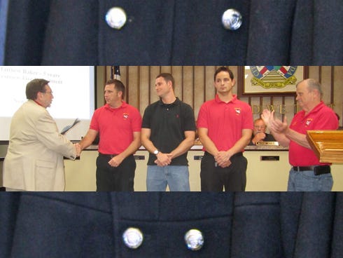 Mayor David Cadle presents five-year anniversary certificates to firefighters Matthew Baker, Matthew Cunningham and Paul Wojtowicz as Fire Chief Joe Traylor, right, applauds.