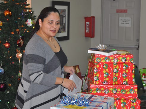 Maria Salazar organizes gifts from Prison Fellowship International’s angel tree program at St. Mark United Methodist Church in Crestview. Children with incarcerated parents will receive the gifts.