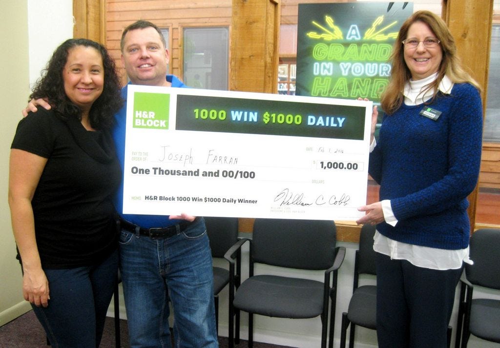 Blanca and Joseph Farran pose with their H&R Block tax preparer Donna Fleming after winning $1,000 in the company's nationwide promotion.