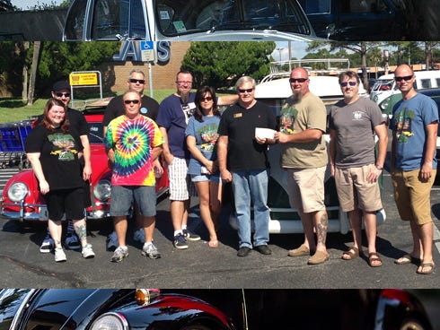 Ken Hair, Children in Crisis president and CEO, receives a $1,650 donation from Steve Osborn, president of Kusten Kruezers Volkswagens of the Emerald Coast. Other members of the car club joined them for the check presentation.