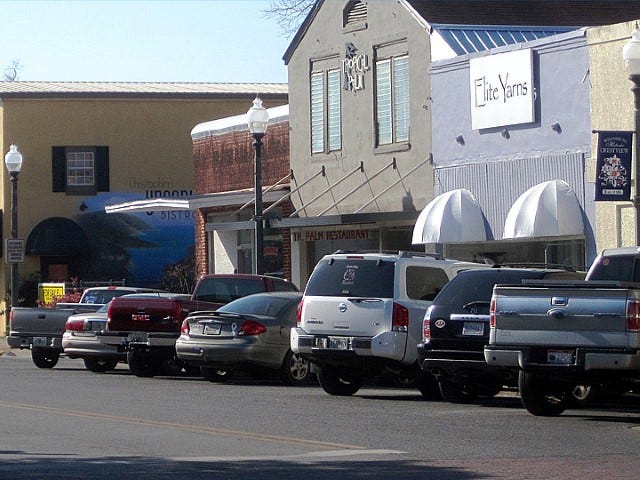 Vehicles fill every Main Street parking spot in front of the Tropical Palm during lunchtime. A recent study suggests limiting lunchtime parking to two or four hours.