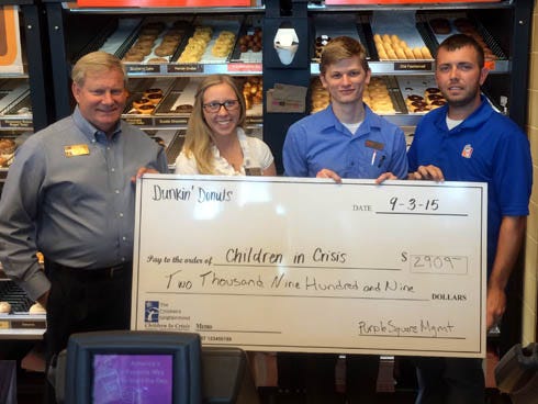 Ken Hair and Lauren Walls — Children In Crisis president and events director, respectively — receive a $2,909 check from Bryce Dewitte and Gerrod Nicola of Dunkin' Donuts and Purple Square Management. The donation will help feed, clothe and support at-risk children living at the CIC Children's Neighborhood in Fort Walton Beach.