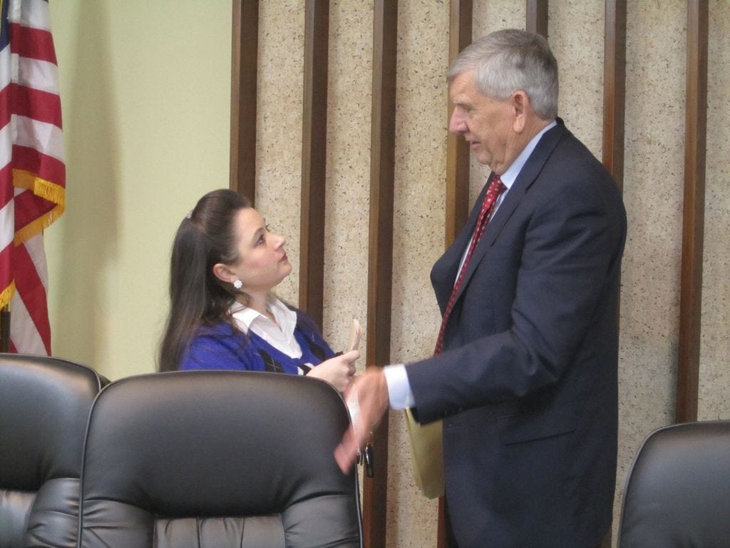 Former Crestview city attorney Ben Holley talks with former city councilwoman Robyn Helt in this January 2012 photo. Holley has been reappointed as the city's attorney.