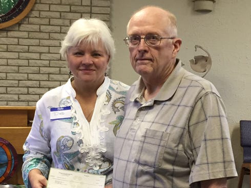 Debra McDaniel, Executive Director of Opportunity Place accepts a recent donation from Unitarian Universalist Fellowship of the Emerald Coast president John Holt. Church members donated about $700 to the organization.