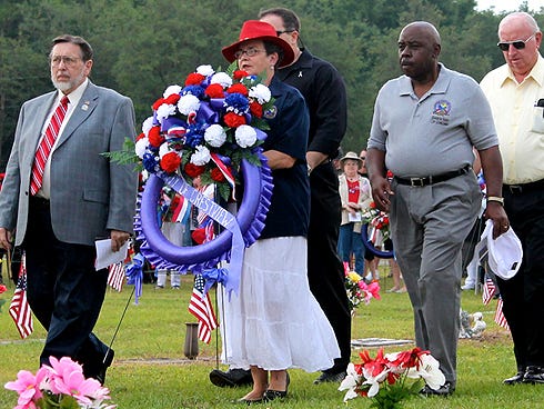 Crestview Mayor David Cadle, left, walks with City Council members to place a wreath during the Disabled American Veterans Auxiliary Crestview Unit 57's Memorial Day ceremony at Liveoak Park Memorial Cemetery.