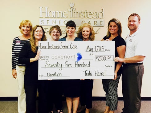 Rachel Mayew of Covenant Hospice, center, accepts a check from the team at Home Instead Senior Care. From the left: Elaine Gates, Tammy Feora, Pam Gemoules, Dee Bocchino, Carly and Todd Harrell.