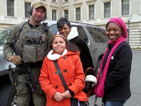 Crestview fourth-grader Justice Livingston, her cousin Tonya Lewis and friend Kiana Ruffin discovered security was omnipresent in Washington, D.C., as they met this FBI agent.