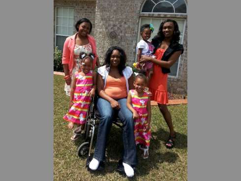 Britainy Pate appears with her daughters and other family members at her parent's house in Crestview. Pate hopes to walk again after experiencing what has been called stress-related paralysis.