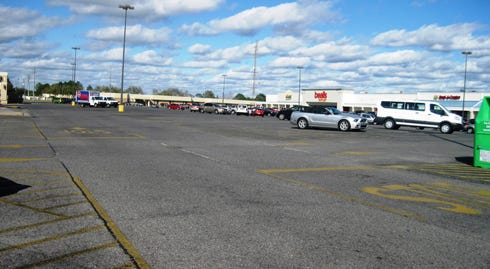 This parking lot lane through the Crestview Corners shopping center would become a connector road between Hospital Drive and Redstone Avenue East, with planted, curbed islands defining it from parking aisles on either side.