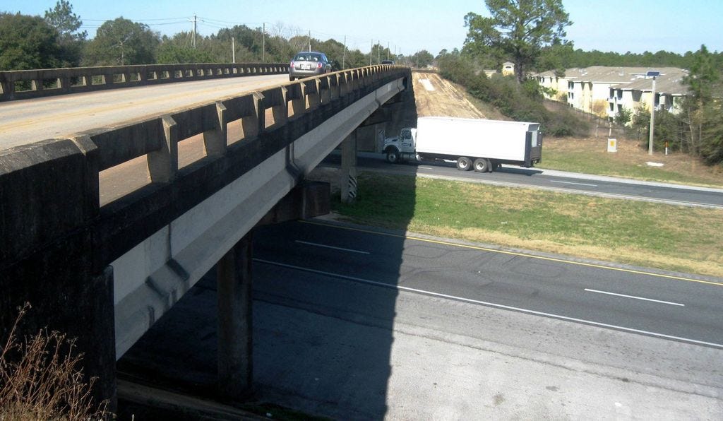 Traffic flows north on the Antioch Road overpass above Interstate 10 in Crestview. Development, such as the Bel Aire Terrace Apartments complex, top right, will make any future interchange a challenge.