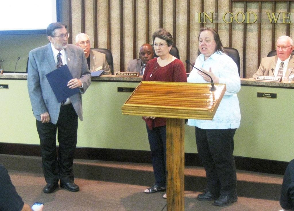 Crestview Growth Management Director Teresa Gaillard, right, and Mayor David Cadle recognize employee Marsha Johns' 20 years of service to the city