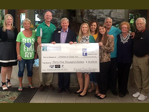 Lynn Dominic, Emerald Coast Foundation board president, and board members present a $35,000 donation to Ken Hair, Children in Crisis president and CEO; Lauren Walls, CIC volunteer and events director; and Allie Noah, CIC development director.