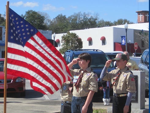 Area Webelos present the colors during the annual Stand Up and Say the Pledge ceremony Monday.