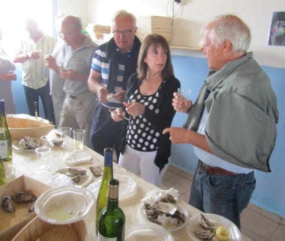 Marie Anne Fella and Rip Coleman, right, discuss Noirmoutain oysters as Coleman's French host, Patrice Videlier, observes.