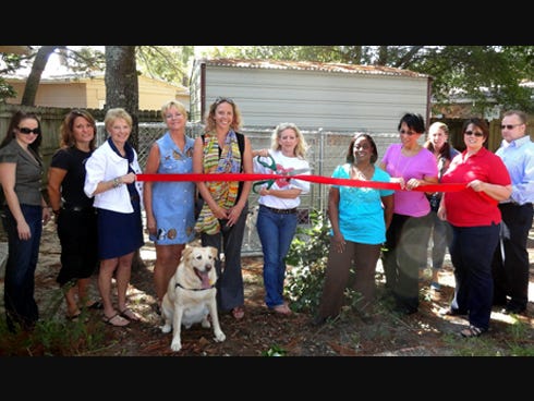 Attendees celebrated the kennel's opening Oct. 7 with a ribbon cutting. The kennel is on-site near a Shelter House home for domestic violence abuse victims.