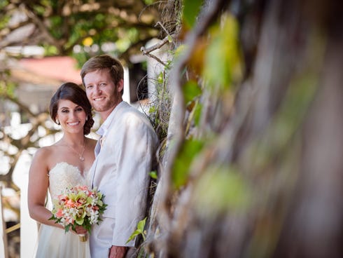 Dr. Sarah Brooke Syklawer and Christopher Adam Howle's romance began with a Mardi Gras ball and solidified with a Jamaican wedding.