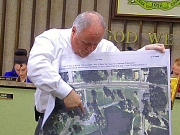 Crestview Public Works Director Wayne Steele indicates the location of a proposed skate and dog park on an aerial photo of Twin Hills Park.