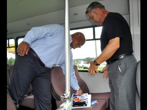 The Rev. Charles Braneff, Calvary United Church’s pastor, right, watches as Hub City Ford general manager Chris Daggs stores school supplies for needy children inside a van.