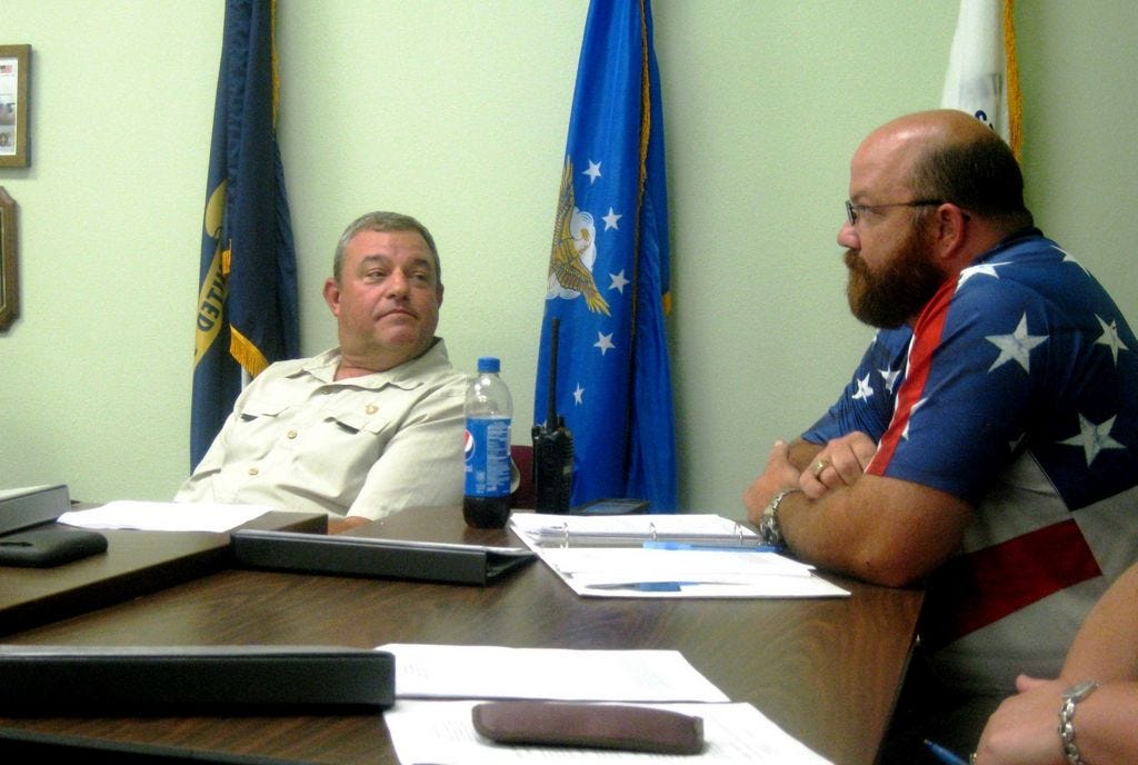 Laurel Hill City Councilman Scott Moneypenny glances at Councilman Travis Dewrell during debate on Dewrell's motion to end dissolution discussions.