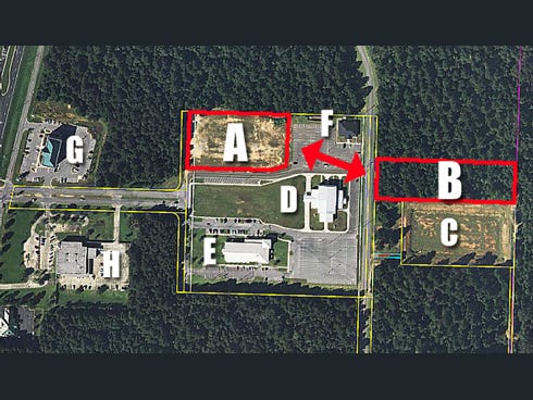 This aerial view of the Crestview civic center area shows the two parcels of land being considered for a swap. The city-owned lot, A, has restrictions while the parcel, B, offered by the landowner has none. Landmarks are: C, stormwater retention pond; D, Crestview Community Center; E, Crestview Public Library; F, Crestview Area Chamber of Commerce; G, First NBC Bank; and H, post office.