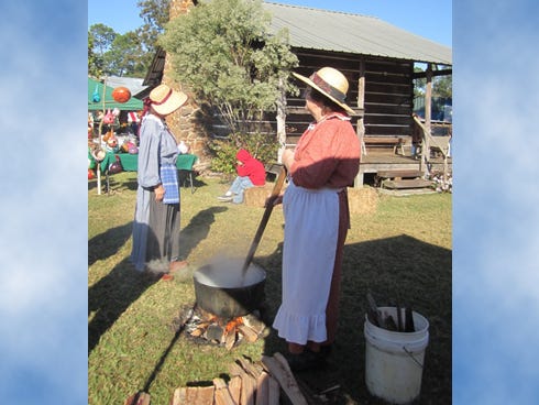 North Okaloosa Historical Association volunteer Dean Hall, right, makes lye soap during the 2011 Baker Heritage Day festival.