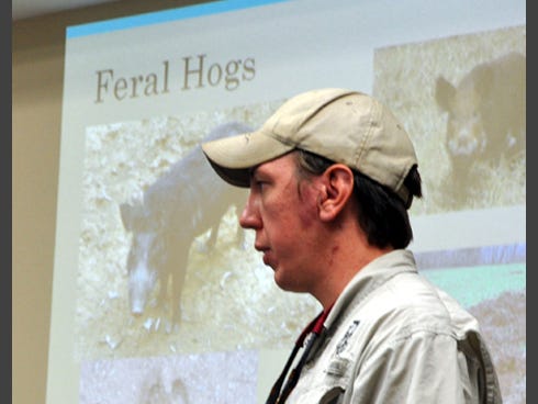 Andrew Lee, a wildlife biologist with the Florida Fish and Wildlife Commission, answers questions on feral hogs during a recent meeting at the University of Florida-Okaloosa County extension office in Crestview.