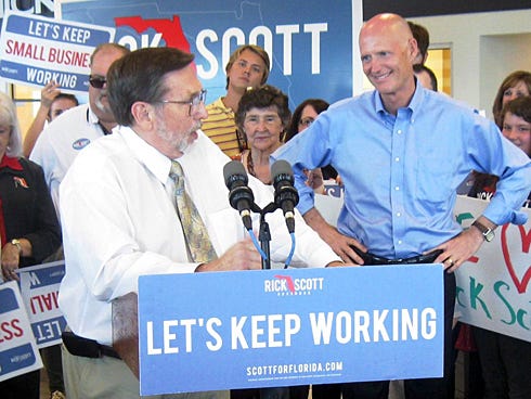 Crestview Mayor David Cadle welcomes Gov. Rick Scott, right, and his entourage during Scott's Thursday afternoon visit to Crestview.