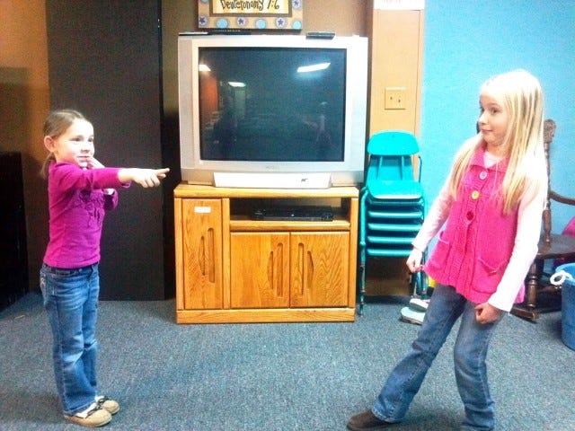 Allie Howard and Maili Odom practice stagecraft skills in a recent KidzAct class.