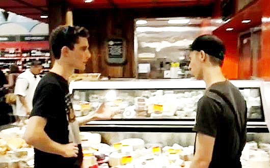 Théo Toulat, a business major at the University Nantes, France, chats about "fromage"--cheese--with a clerk at the Destin Whole Foods grocery.