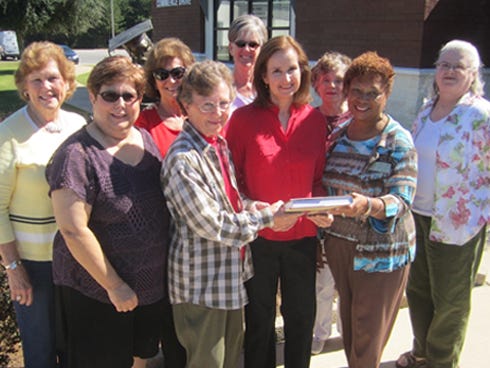Dogwood Garden Club members celebrate a book donation to the Crestview Public Library in honor of Celia Broadhead, their Woman of the Year. From left are Eva Fountain, Ruth Herington, Judy Rice, club president Sarah Petty, Thea Duhaimy, Broadhead, Beach Campbell, Library Director Jean Lewis and Jane McCreary.