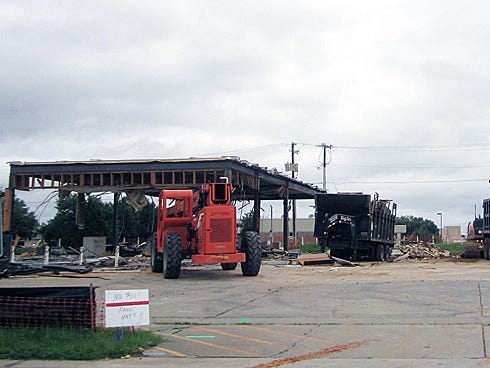 A demolition crew razes a former gas station on the site of a Krystal hamburger restaurant planned for south Ferdon Boulevard opposite Dunkin' Donuts.