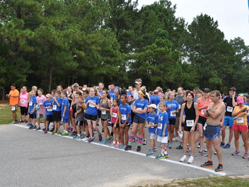 Nearly 300 participants gather at the starting line for the #Runfor Drew 5K at Davison Middle School on Saturday. With registration fees, donations and sponsorship from local businesses, event organizers estimate that the fundraising event raised nearly $7,000 for the family of Drew Barefield. Drew was critically injured in a boating accident on June 28.