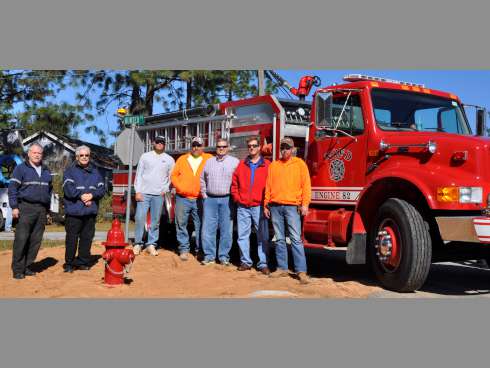 North Okaloosa Fire District and Auburn Water System representatives flank a newly installed fire hydrant on the corner of Reinke Drive and Hunter Drive outside Crestview city limits. From the left are NOFD Deputy Fire Chief Danny Worrells and Fire Chief Ed Cutler, Ron Norville and Patrick Adamson of Auburn Water Systems, NOFD Commissioners Dan Bowers Jr. and Craig Shaw, and Justin Cox, of Auburn Water System.