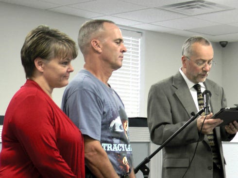 Floyd Spence’s wife, Shannon, accepts the HERO Award on his behalf, along with HERO Award winner Randy Broxson as Administrator Jim Curry addresses the crowd at the Dec. 4 Okaloosa County Commission meeting. Floyd Spence, of Crestview, and Broxson, of Holt, assisted a mother and son following a car accident.
