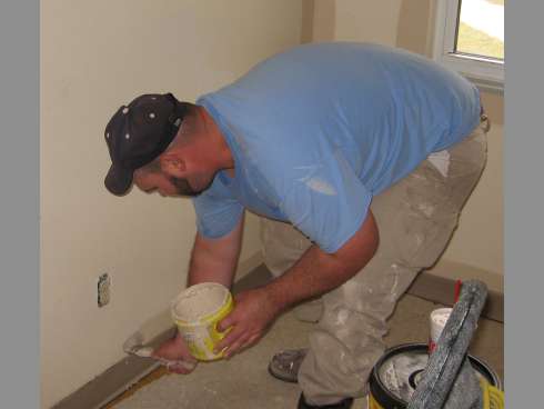J.T. Grandstaff, a Crestview Housing Authority maintenance worker, paints inside a rentable unit. CHA staffers said they have made numerous housing improvements in the past seven years.