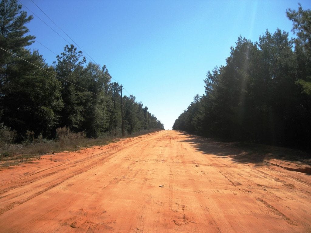 The north 1.8 miles of Fairchild Road, east of Bob Sikes Airport, is dirt. Paving is expected to begin within a month, improving access to Crestview Aerospace, the area's largest private employer.