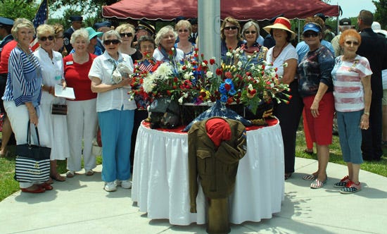 The National Society Daughters of the American Revolution's Choctawhatchee Bay Chapter honored the husband of one of its members, retired Lt. Col. Thompson Lindley, by placing flowers at the flagpole during a May 30 service at Beal Cemetery in Fort Walton Beach. Pictured, from left, are Fort Walton Beach residents Karen Baker and Anne Aderholt; Ann Rumph of Shalimar; Fort Walton Beach residents Joanne Pettey and Ginny Lindley; Amanda Harris of Shalimar; Fort Walton Beach residents Fran Goodall, Mattie Peterson and Lisa Fowler; Regent Caroline Maney of Shalimar; Betsey Plantholt of Fort Walton Beach; Patti Codgal of Crestview; and Joyce Harrington of Fort Walton Beach.