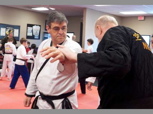 Dr. Alberto Barbon of Crestview spars with an instructor during the Korean Martial Arts Festival on April 20 at Gordon Martial Arts.