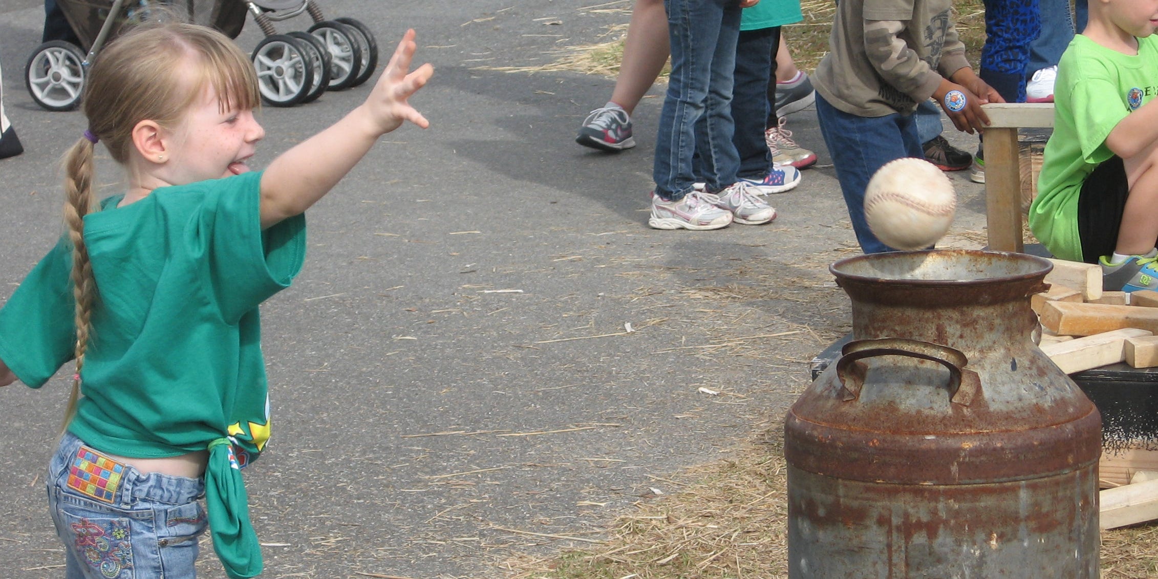 Riverside Elementary School student Cadence Willis, 5, tosses a ball into a canister on Wednesday at St. Mark United Methodist Church’s pumpkin patch. The church, which provided pumpkins to the community throughout October, has closed the patch for the season.